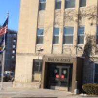 The New York flag billows outside the Ithaca Hall of Justice. Will college programs appear in NY state prisons in the future?